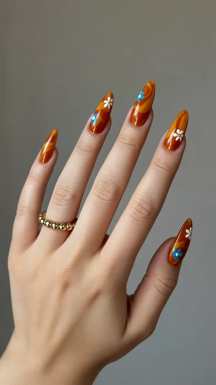 cute spring nail design 2026 Amber Brown Daisy Almond Nails with Glossy Finish