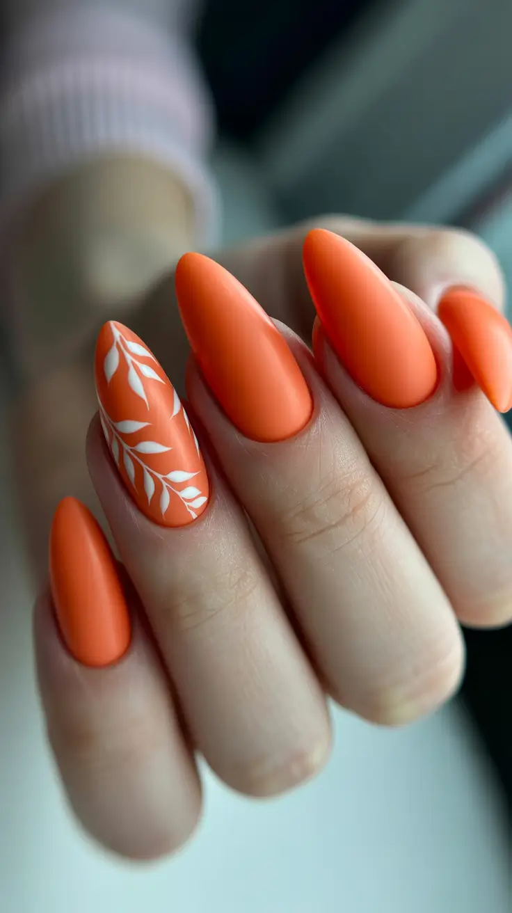 spring orange nails 2026 Matte Orange Almond Nails with White Botanical Art