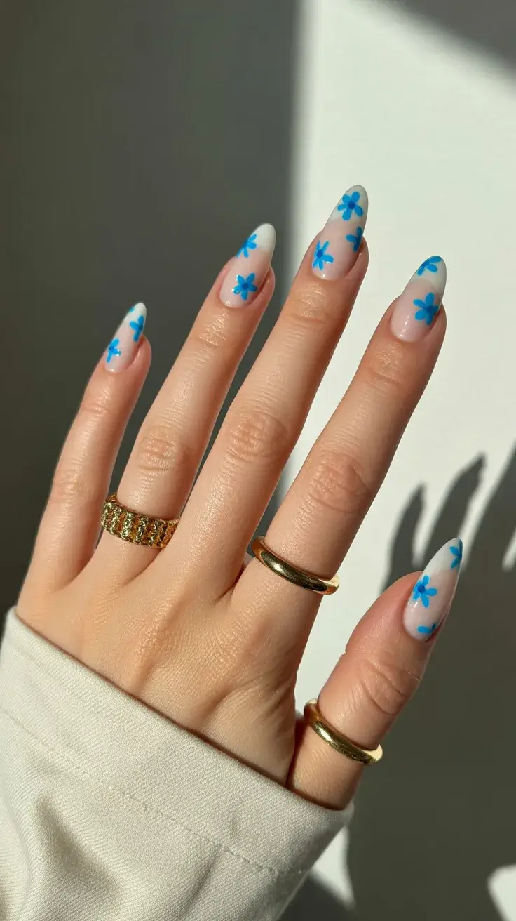 easter nails color ideas 2026 Delicate Blue Daisy Almond Nails