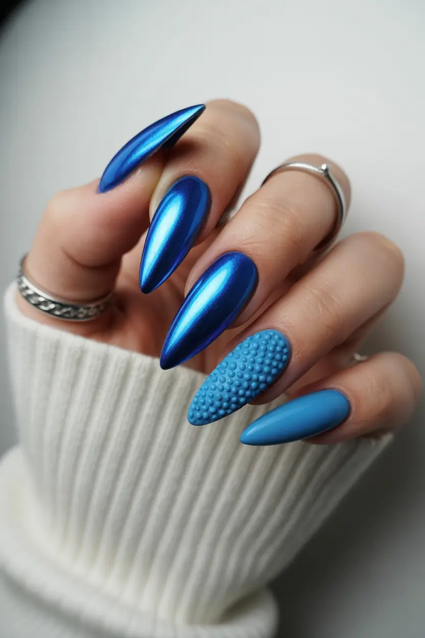 minimalistic spring nail inspo 2026 Metallic Blue Almond Nails with Textured Accent
