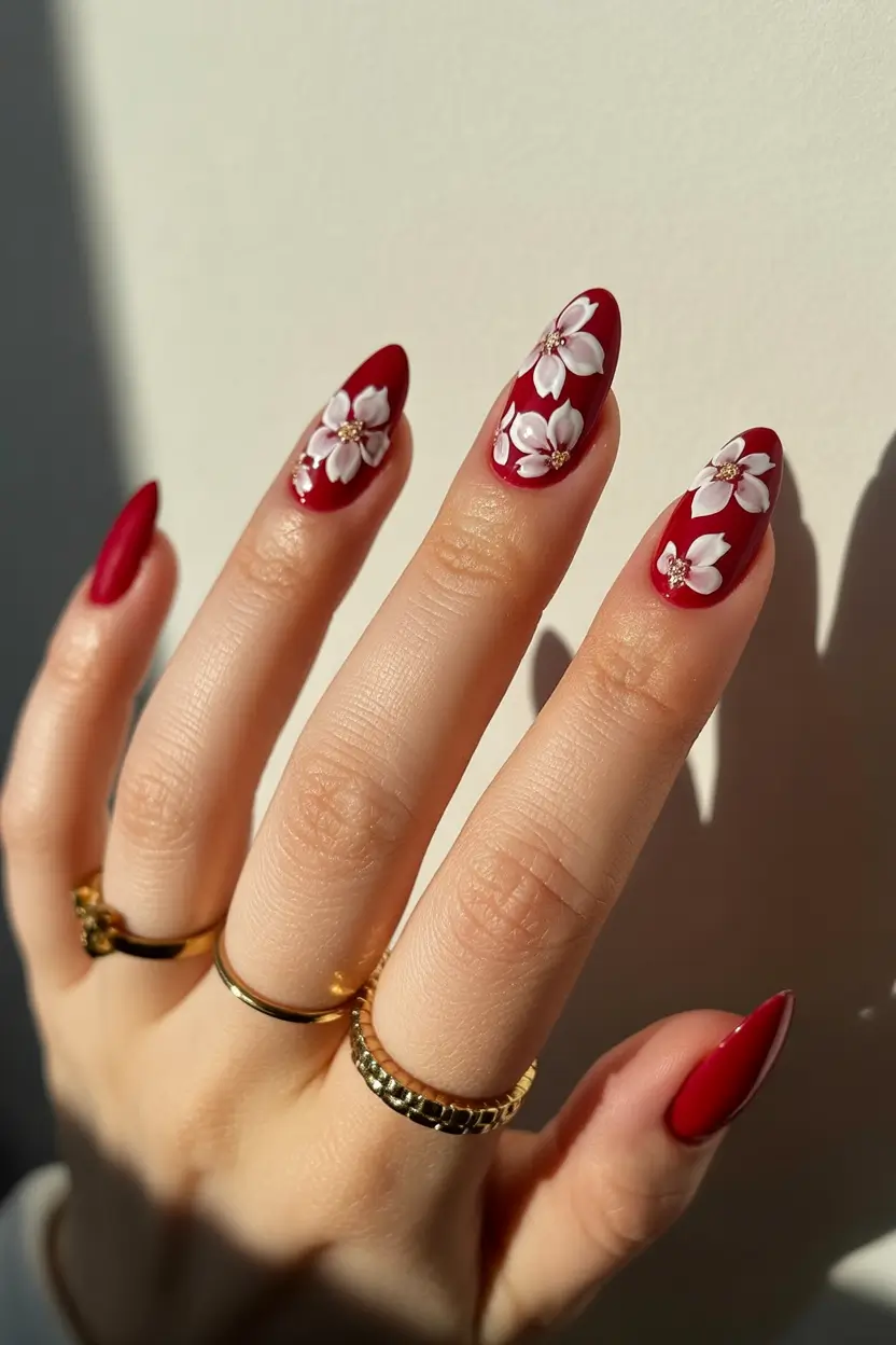 minimalistic spring nail inspo 2026 Classic Red Almond Nails with Delicate White Floral Art