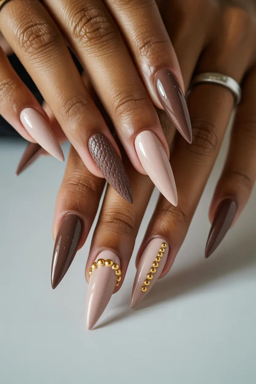 spring nails for dark skin 2026 Neutral Brown Stiletto with Texture and Stud Detail