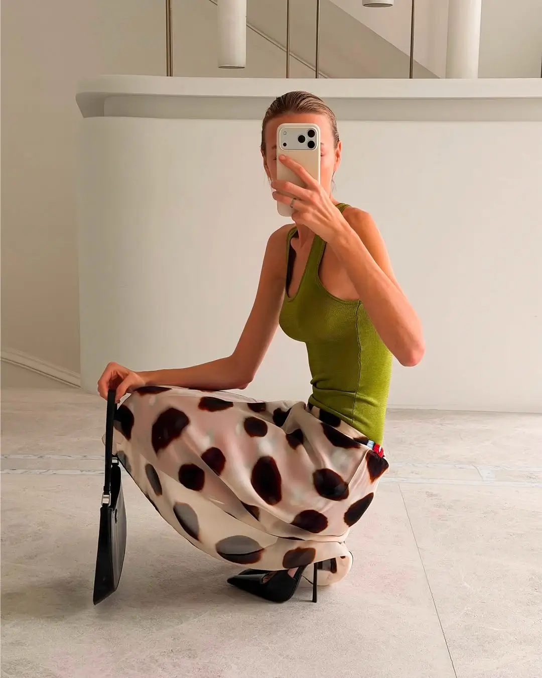 every day summer outfits 2026 Minimal tank and statement skirt combination