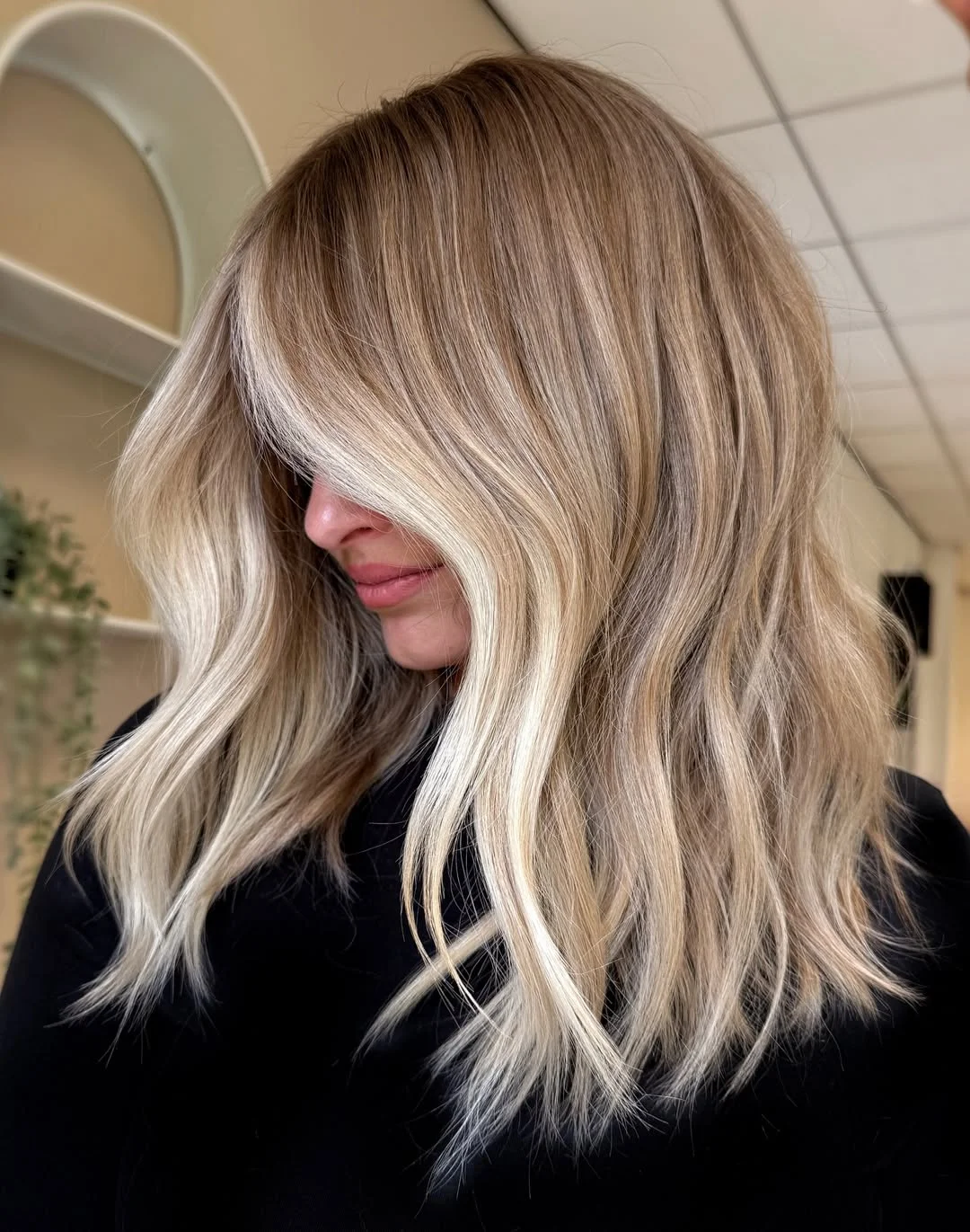 flattering summer haircut for round face 2026 Cool-Toned Blonde Layers with Effortless Movement