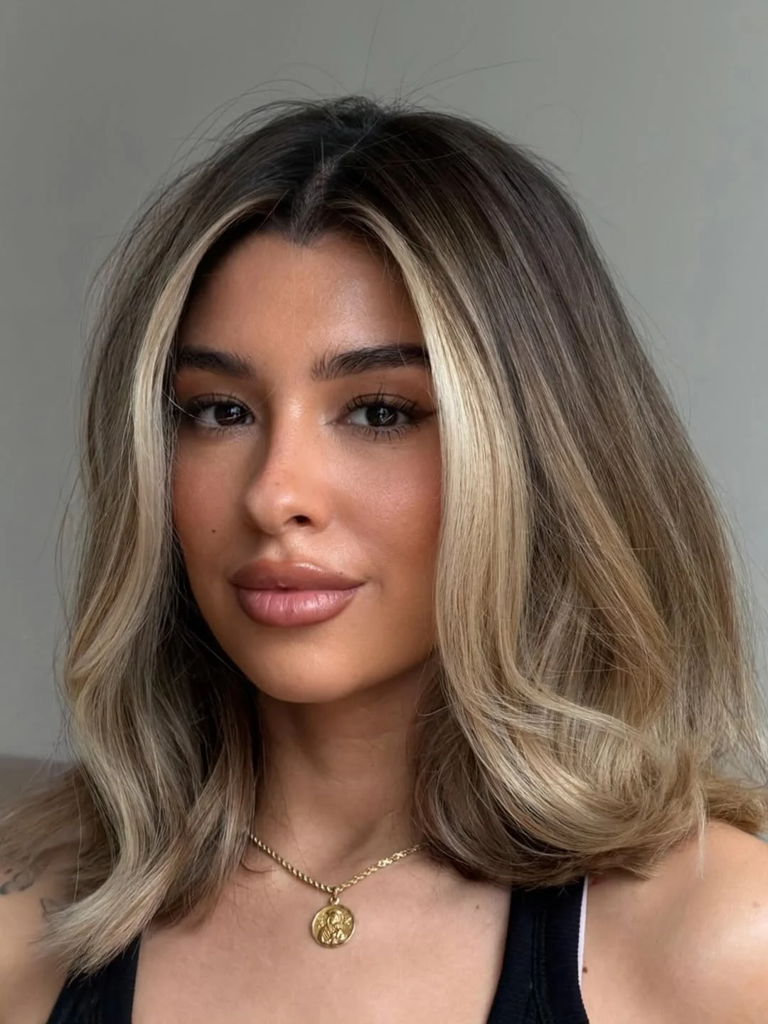 flattering summer haircut for round face 2026 Dimensional Blonde with Subtle Front Highlights