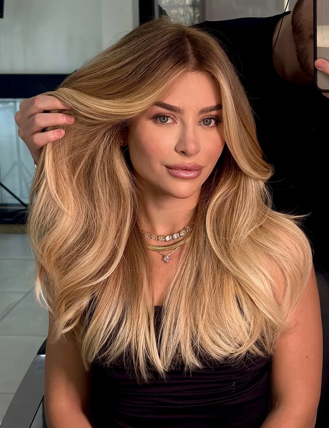 flattering summer haircut for round face 2026 Voluminous blonde layers that lift and elongate