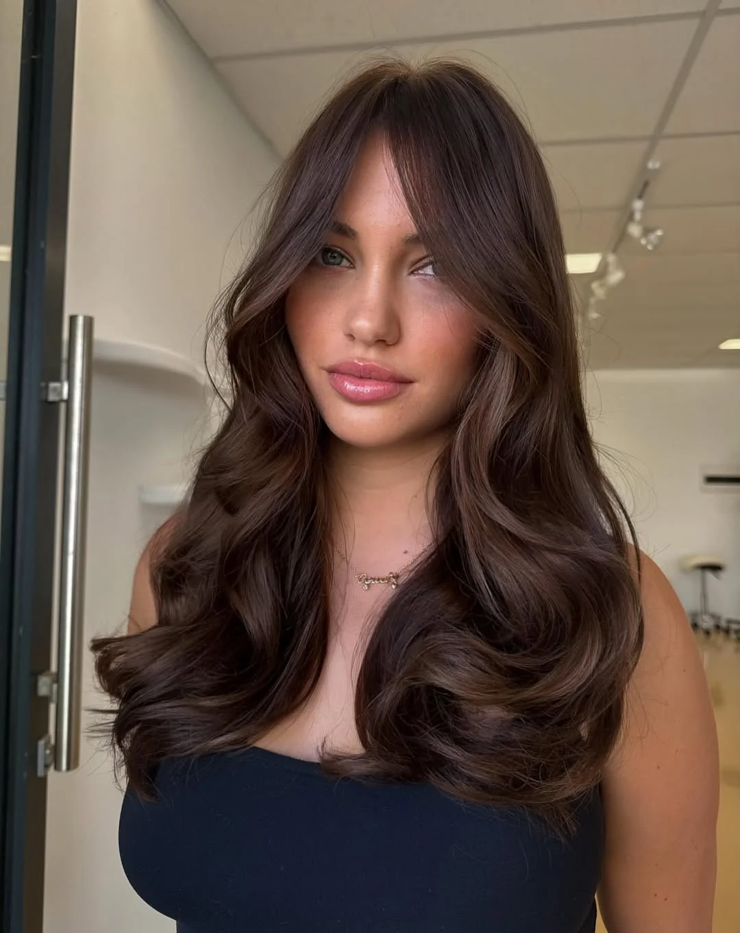 layered summer haircuts for medium hair 2026 Rich brunette layers with soft front movement