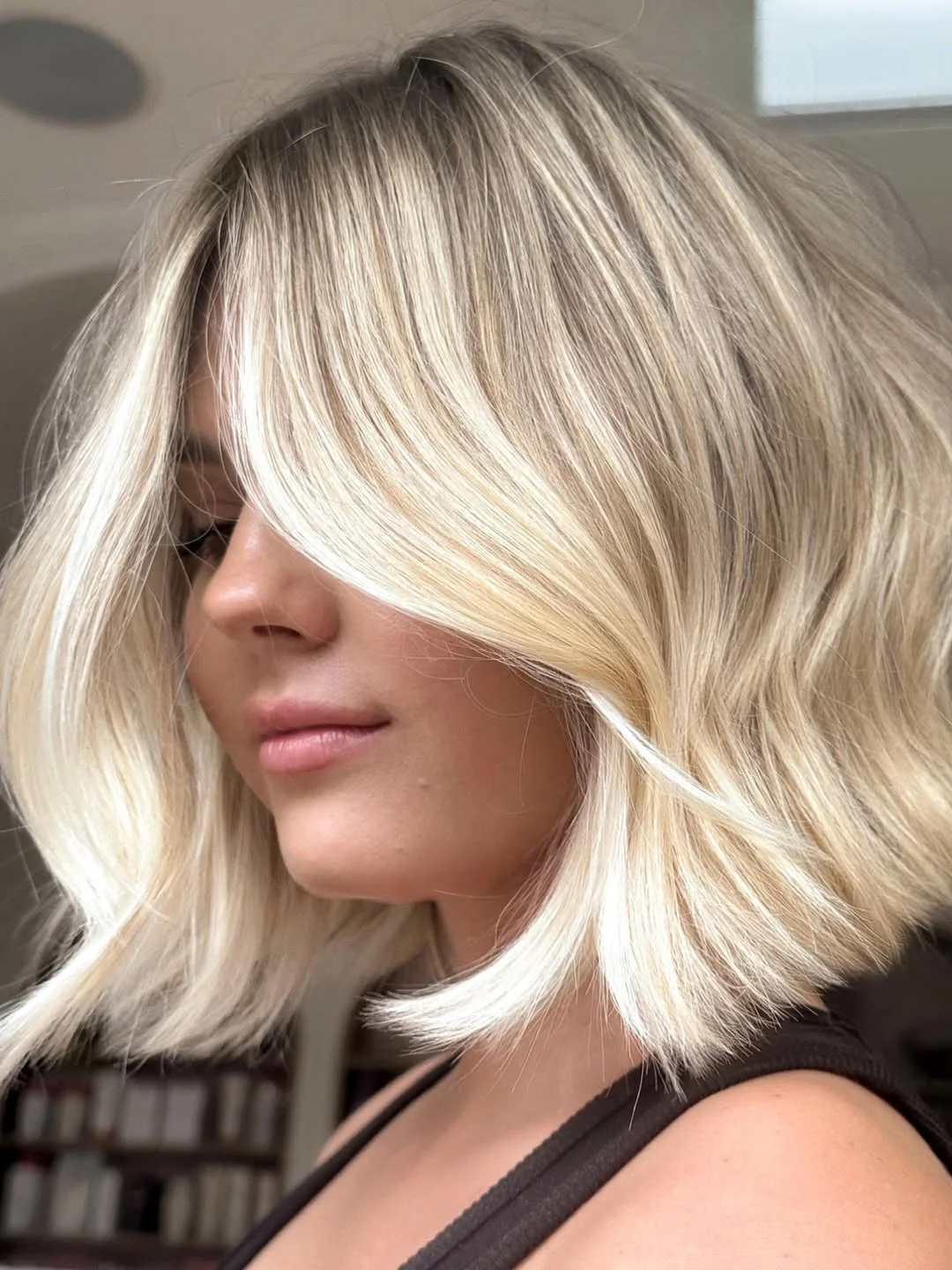 layered summer haircuts for medium hair 2026 Feathered blonde layers with soft face framing
