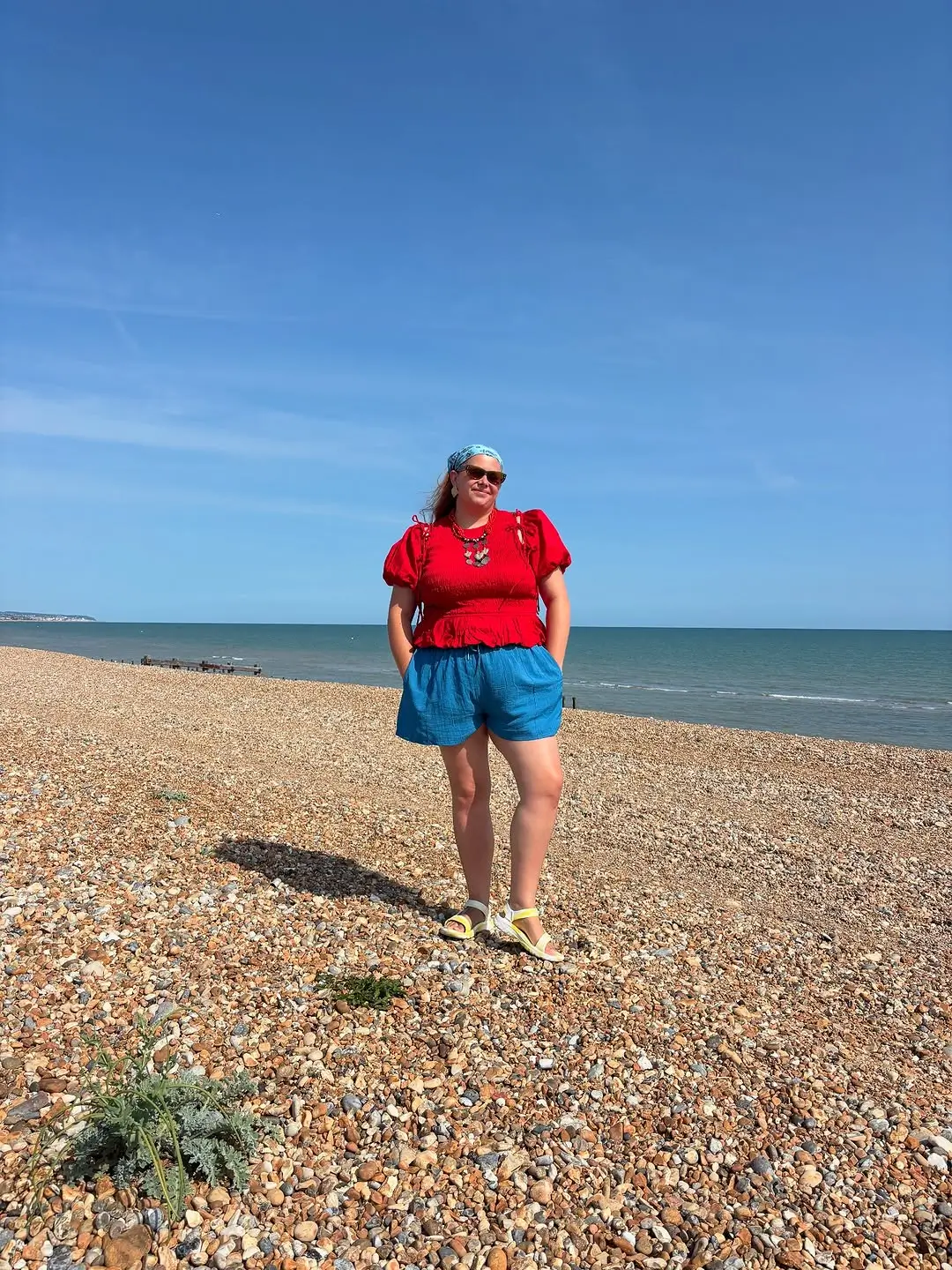 plus size summer outfits 2026 Bright Red Top and Shorts for a Casual Beach Day