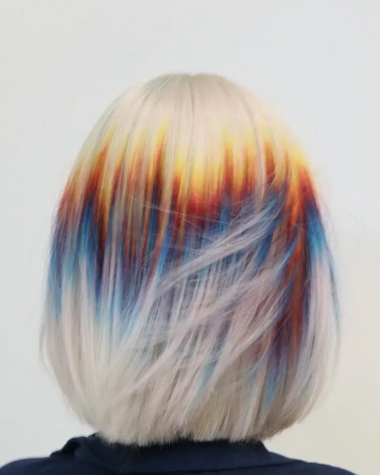 summer blonde hair color for women 2026 Creative Platinum with Red and Blue Underdye