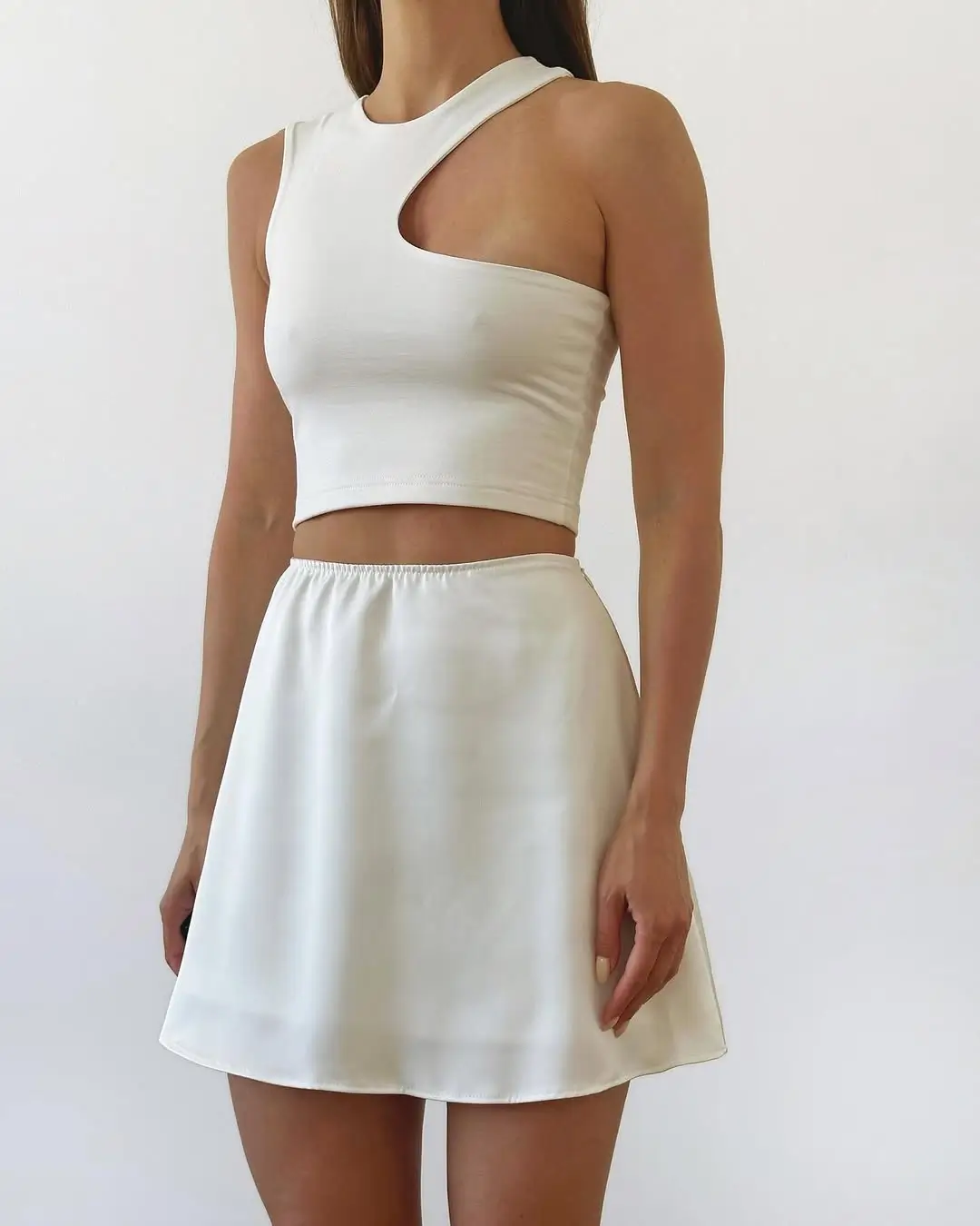 summer crop top outfits 2026 Minimal white crop with soft skirt silhouette