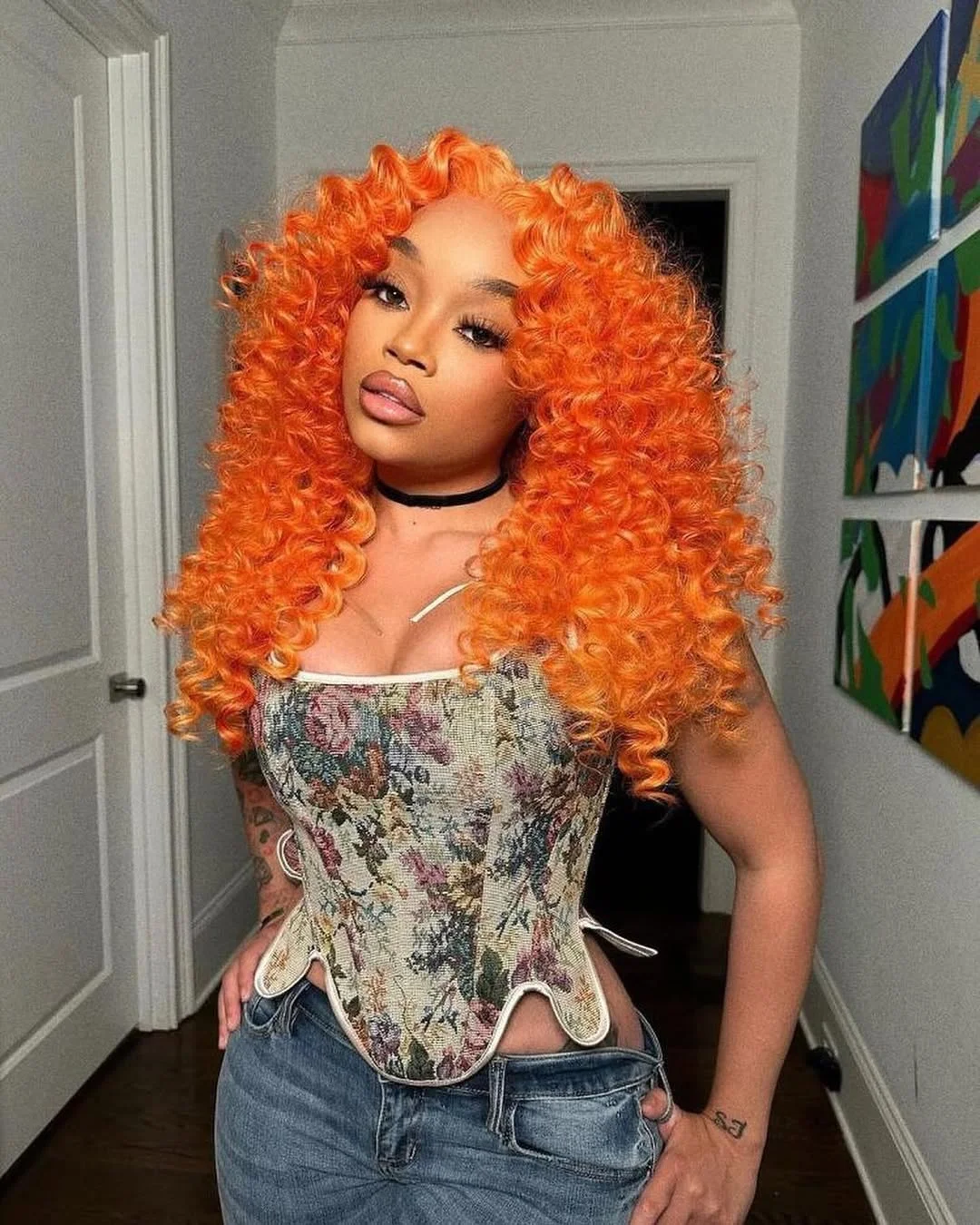 summer hair color for brown skin women 2026 Voluminous Fiery Orange Curly Statement