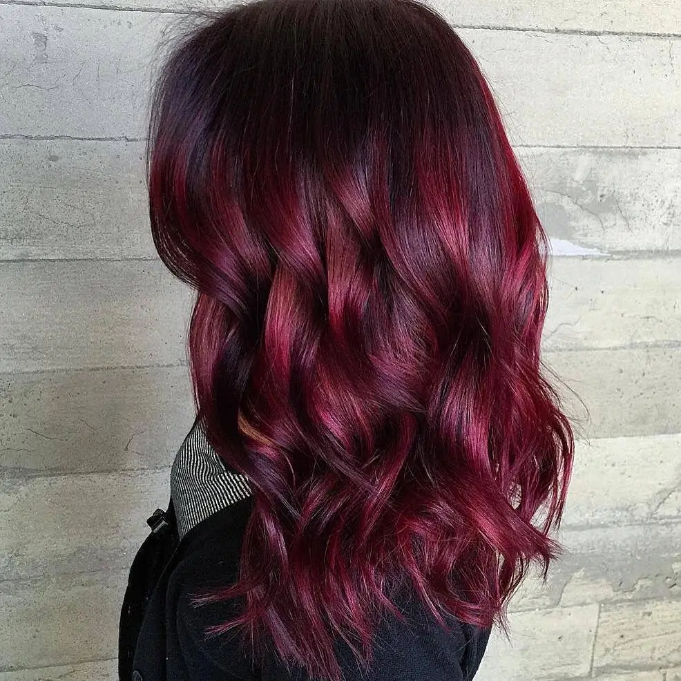 summer hair color for dark skin women 2026 Deep red waves with a glossy summer finish