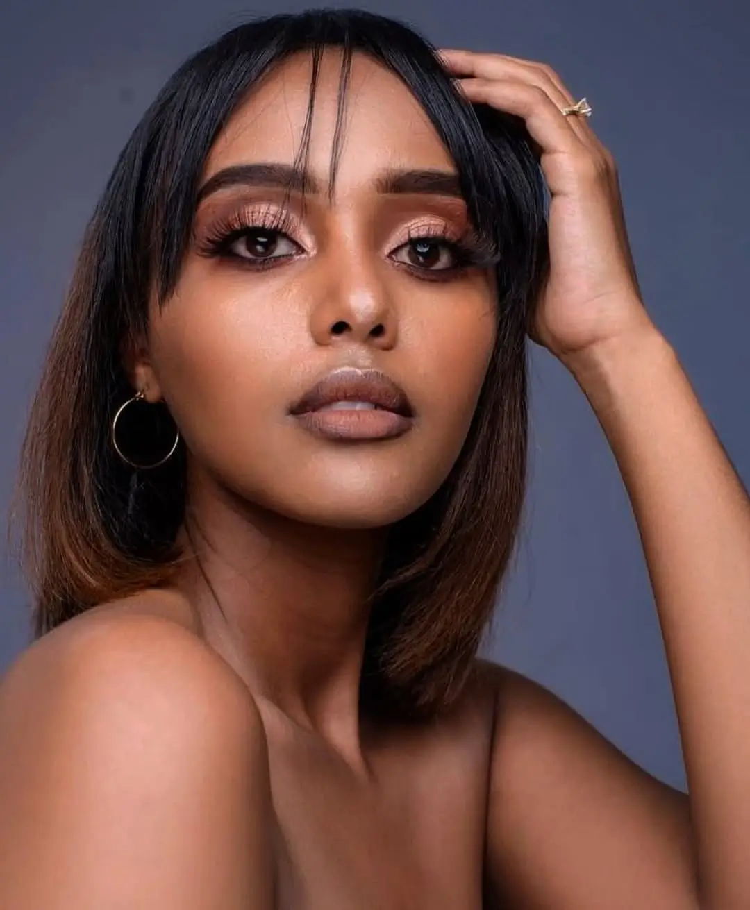 summer hair color for dark skin women 2026 Soft Indian tone bob with airy bangs