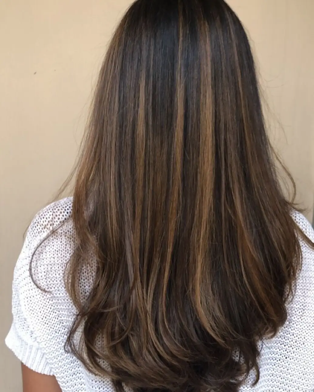 summer hair color for dark skin women 2026 Dimensional brown blend with soft peekaboo ribbons