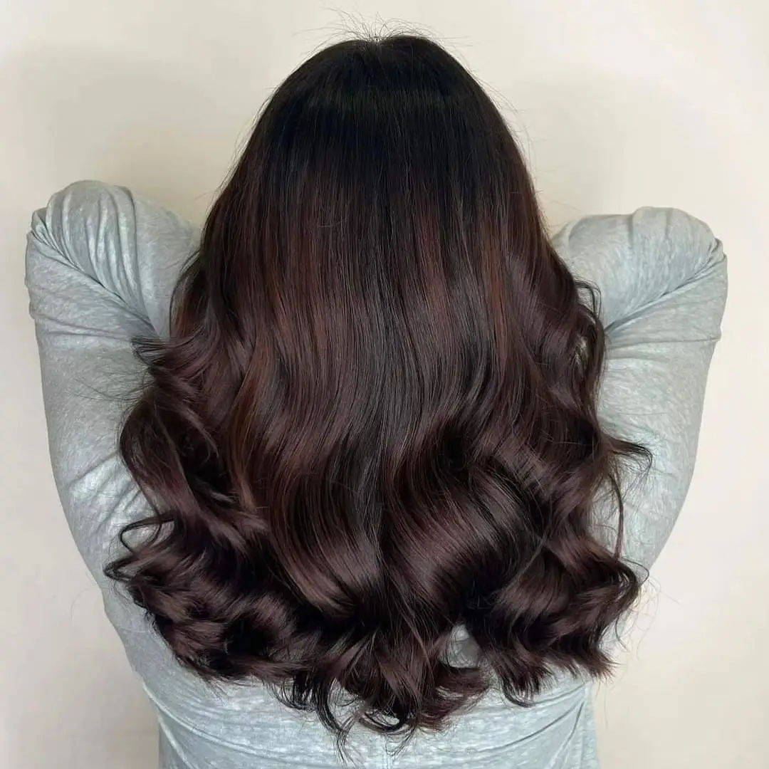 summer hair color for tan skin women 2026 Deep Chocolate Waves with Subtle Auburn Heat
