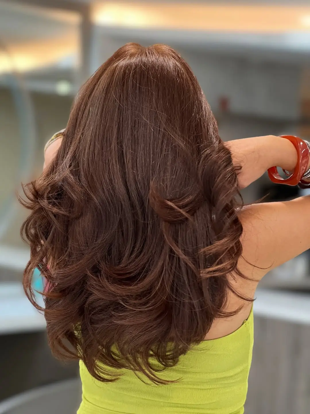 summer hair color for tan skin women 2026 Glossy Cinnamon Brown with Voluminous Layers