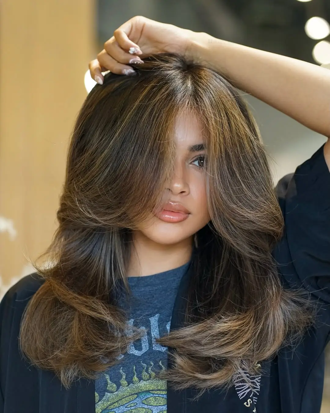 summer hair color ideas for brunette women 2026 Feathered Caramel Layers with a Sunlit Finish