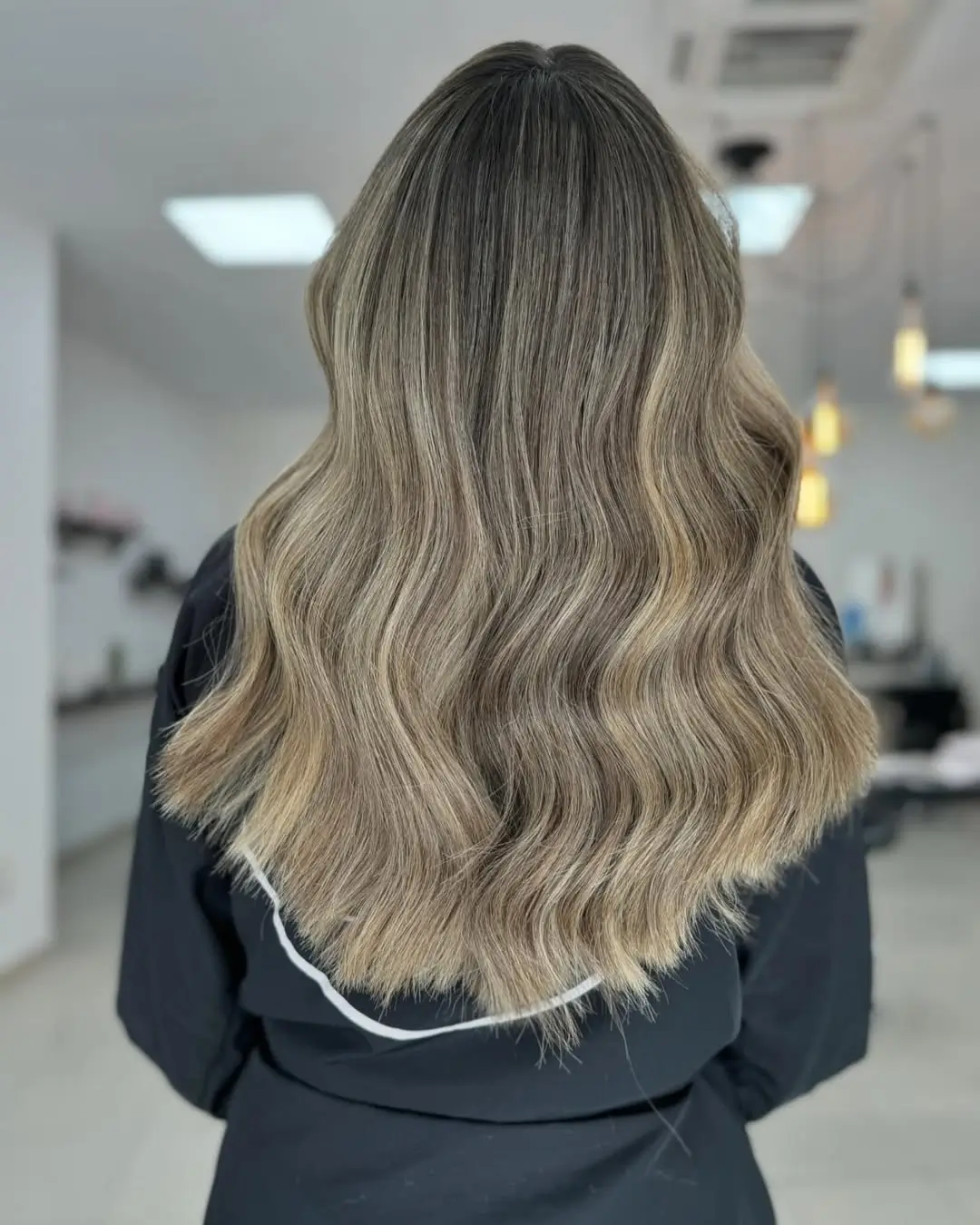 summer hair color ideas for women 2026 Muted Ash Bronde with Seamless Blend