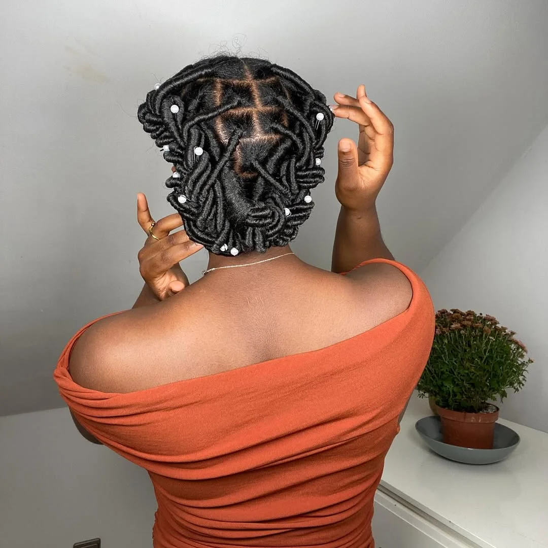 summer hairstyles for black women 2026 Intricate Threaded Updo with Artistic Pattern