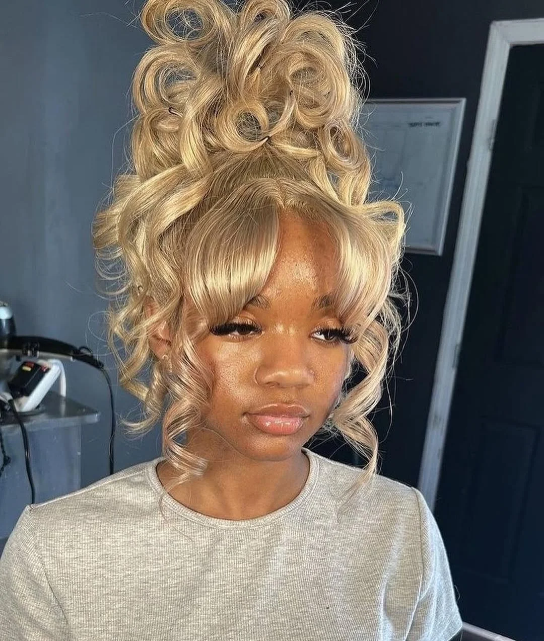 summer hairstyles for black women 2026 Blonde Curly Updo with Soft Fringe