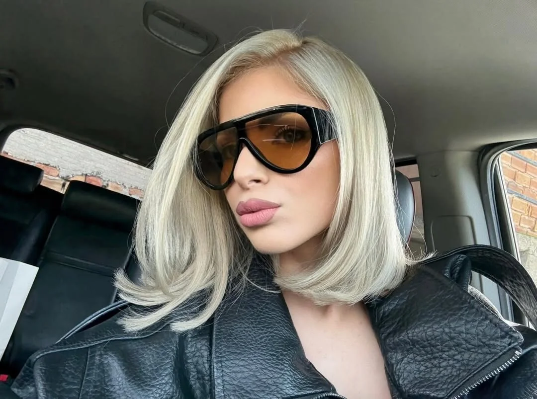 textured summer bob haircut 2026 Glossy platinum curved bob with tucked ends