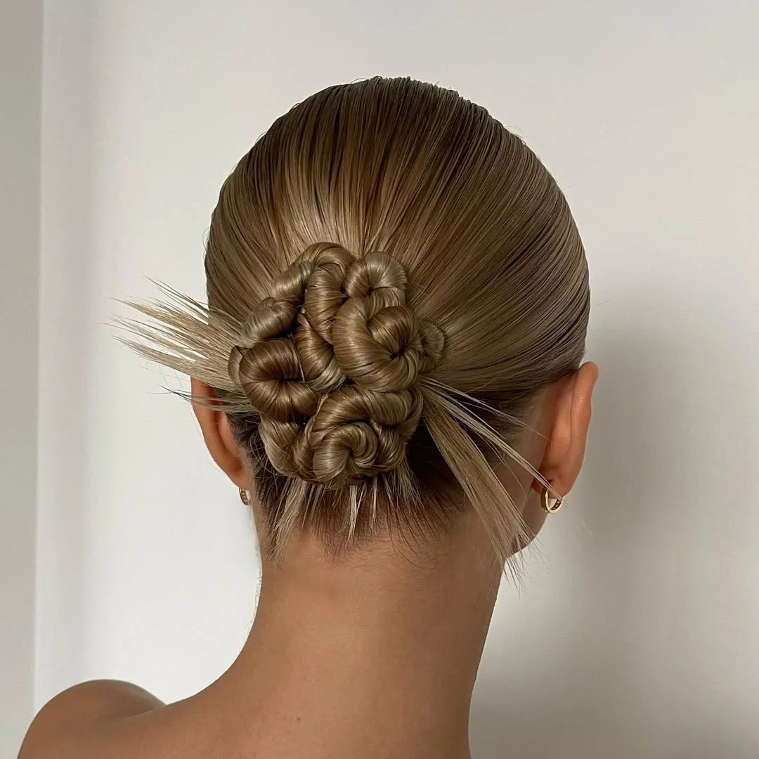 boho summer braids hairstyle 2026 Minimal braided bun with soft sculpted finish
