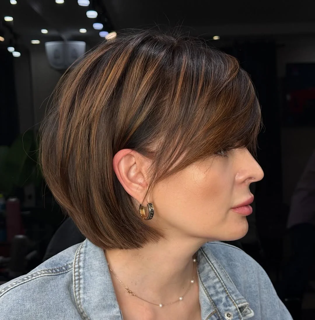 chic summer haircuts for women over 40 2026 Soft layered short bob with side swept bangs