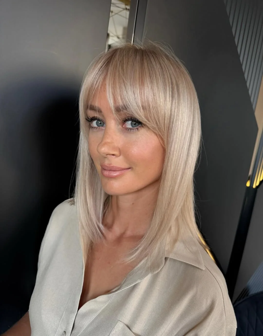 chic summer haircuts for women over 40 2026 Blonde mid length with soft bangs