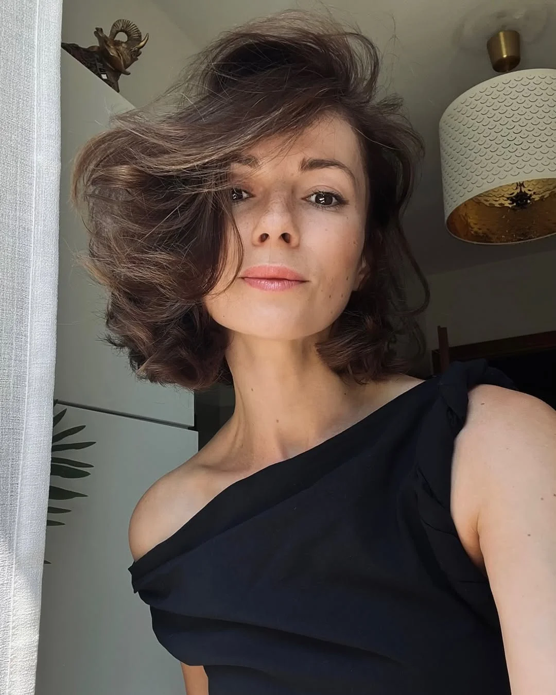 chic summer haircuts for women over 40 2026 Voluminous layered bob with soft shag energy