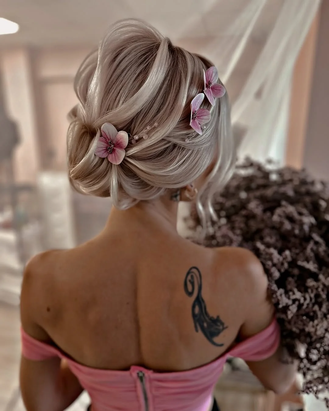 cute summer short hairstyles 2026 Romantic Low Bun with Floral Details