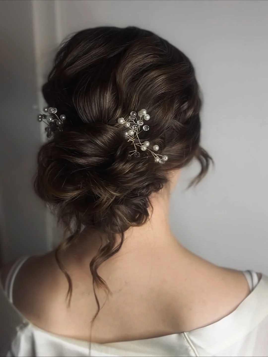 elegant summer updo hairstyles 2026 Low Curly Bun with Pearl Accents