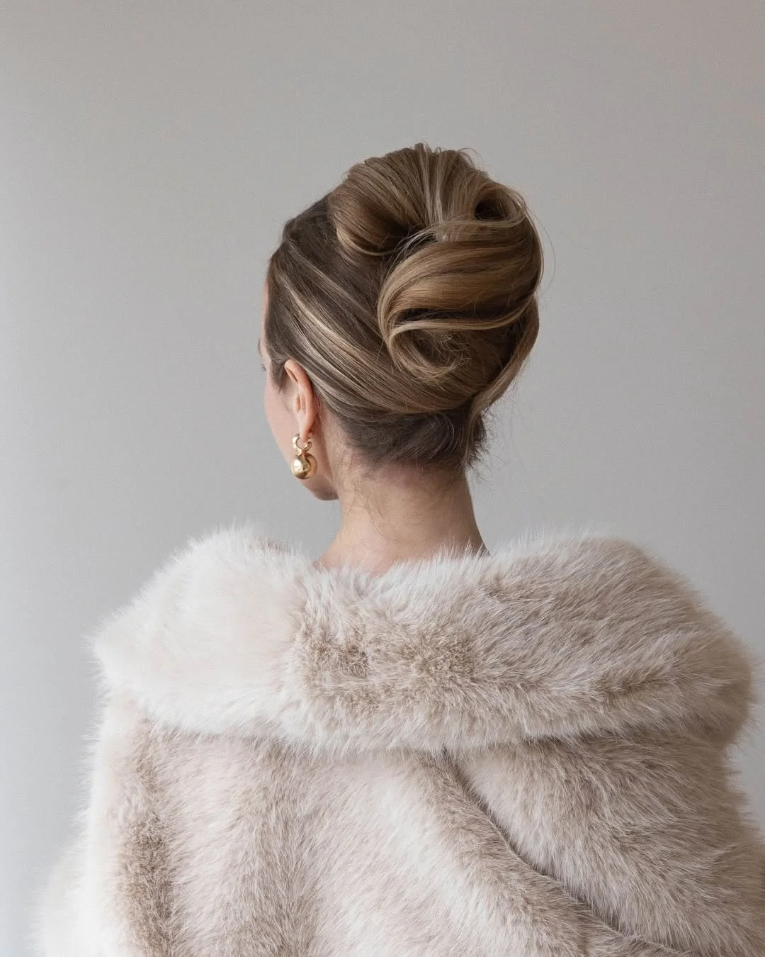 elegant summer updo hairstyles 2026 Polished Classic Bun with Sculpted Volume