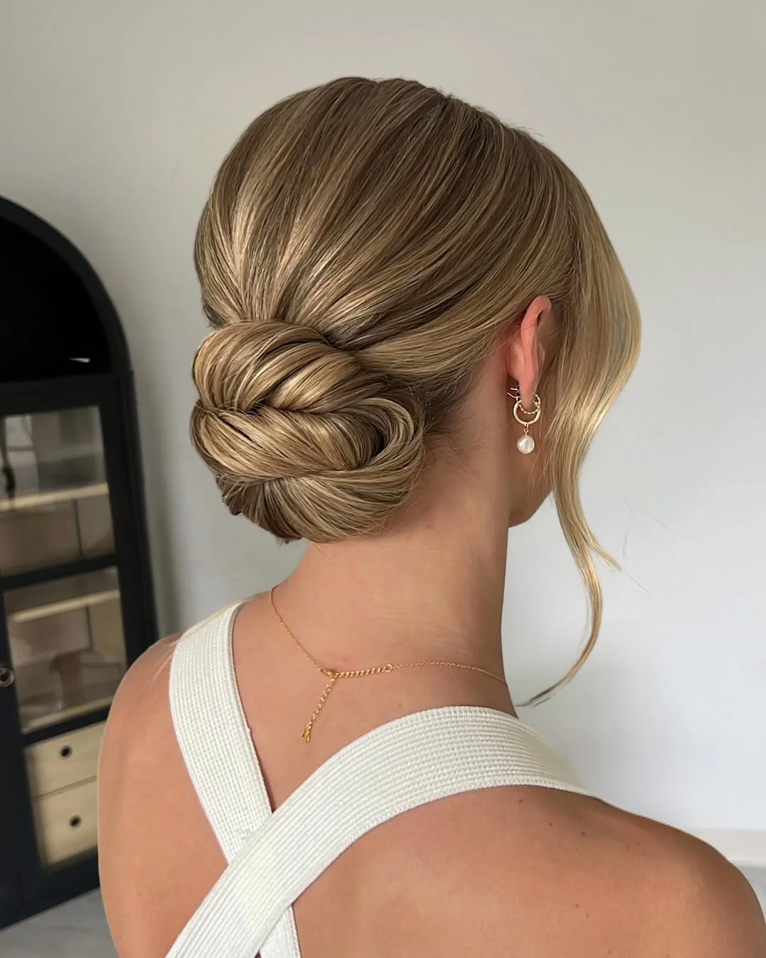 elegant summer updo hairstyles 2026 Sleek Braided Low Bun with Polished Finish