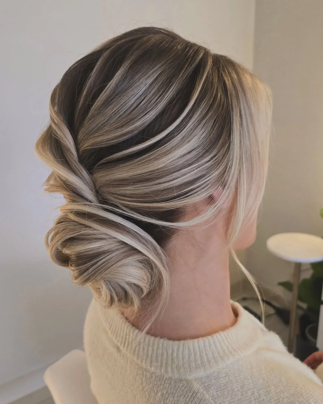elegant summer updo hairstyles 2026 Soft Folded Low Bun with Dimensional Highlights