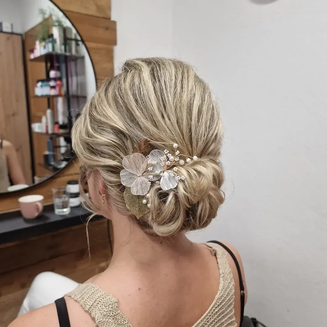 elegant summer wedding guest hairstyles 2026 Low Floral Updo Elegance
