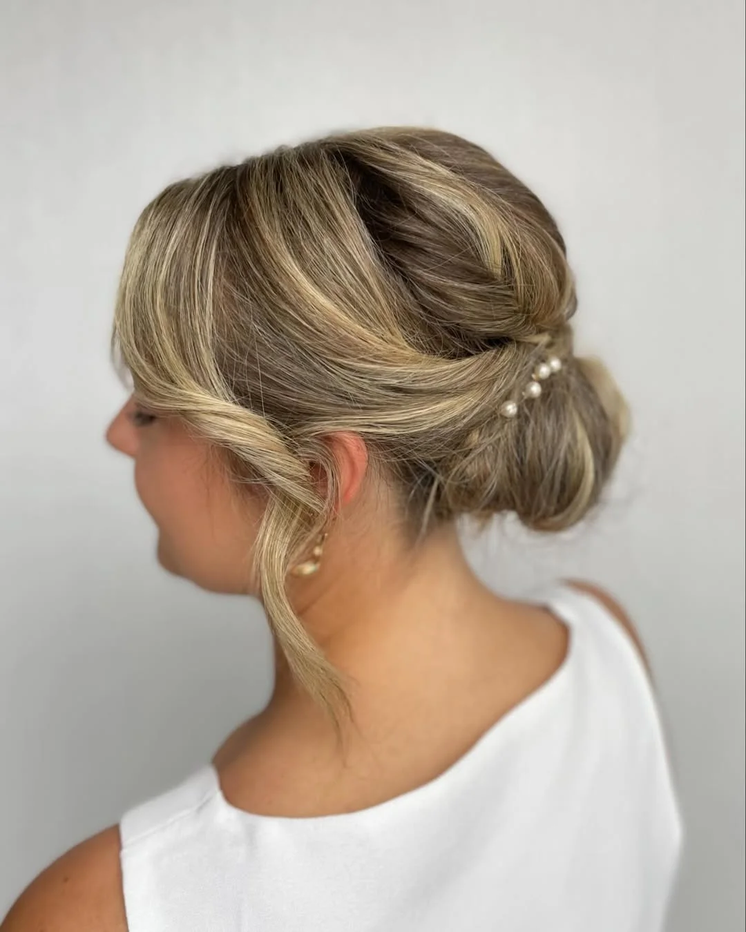 elegant summer wedding guest hairstyles 2026 Soft Pearl Low Bun