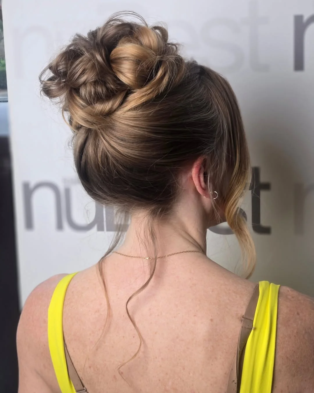 elegant summer wedding guest hairstyles 2026 Textured High Bun Elegance