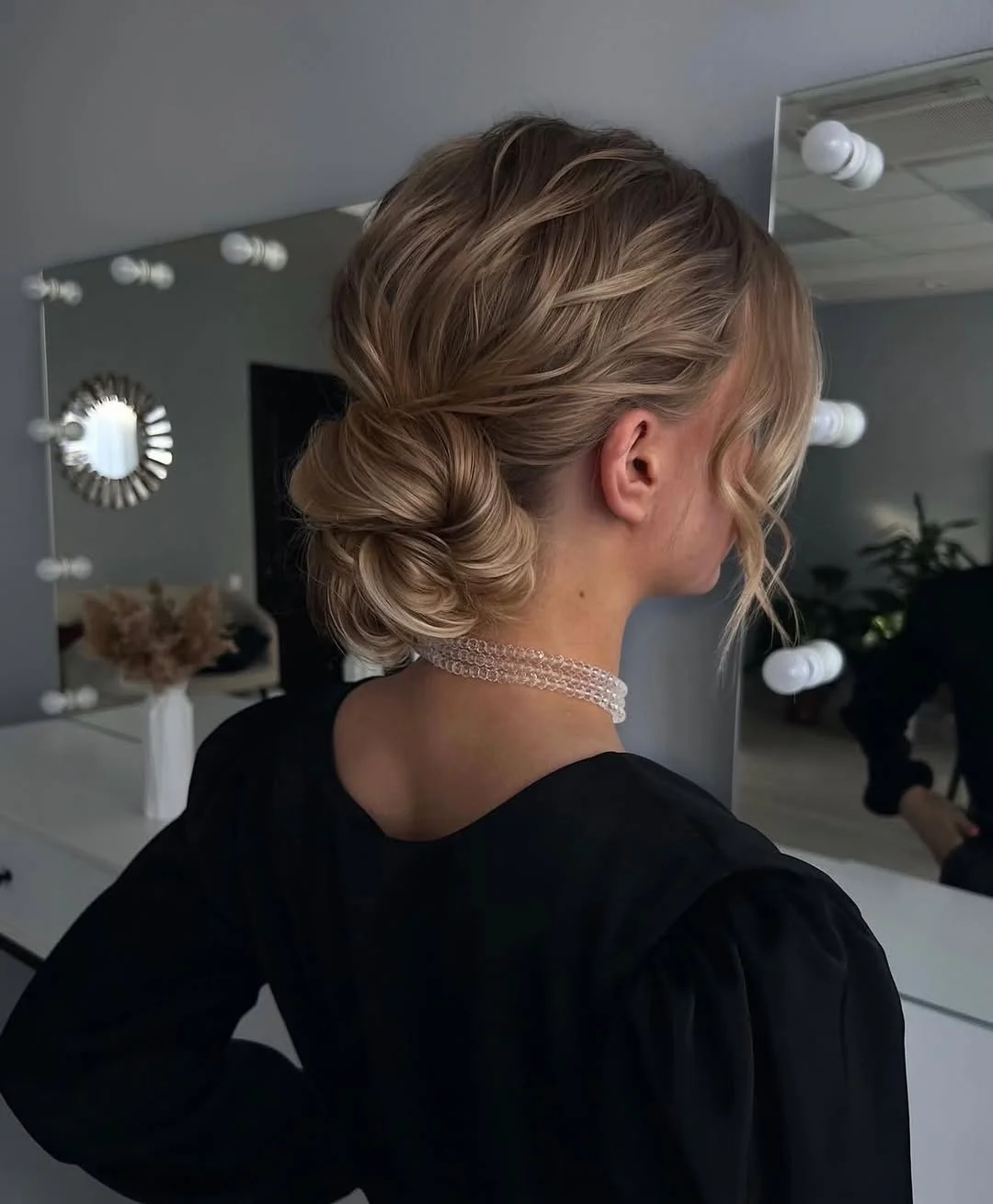 messy summer bun hairstyles 2026 Soft Twisted Low Bun With Summer Shine