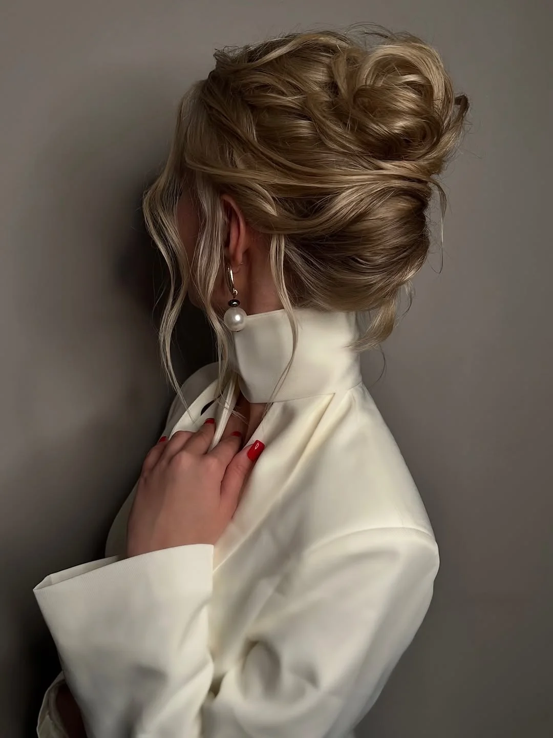 messy summer bun hairstyles 2026 Voluminous Blonde Bun With Romantic Movement