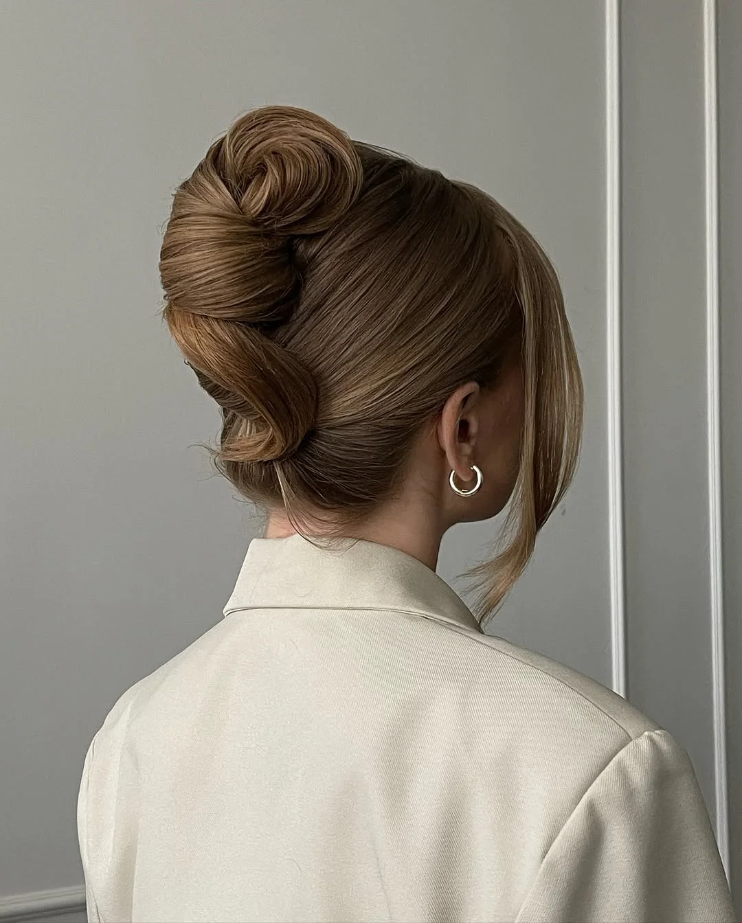 messy summer bun hairstyles 2026 Modern Sculpted Bun With Clean Lines
