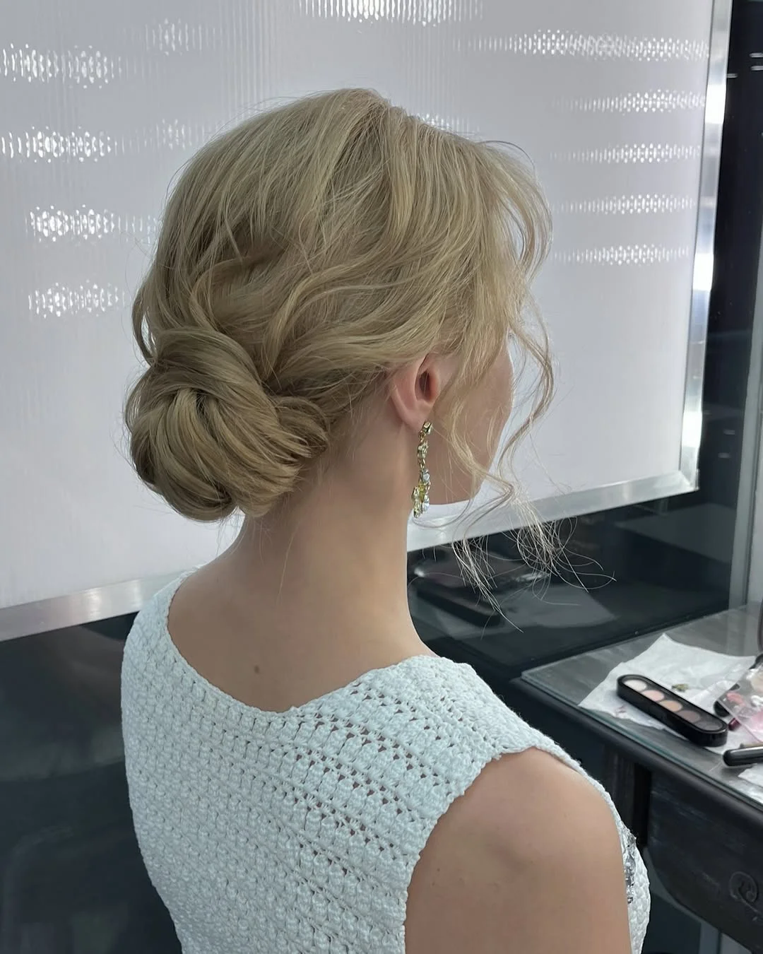 messy summer bun hairstyles 2026 Soft Blonde Low Bun For Elegant Summer Nights