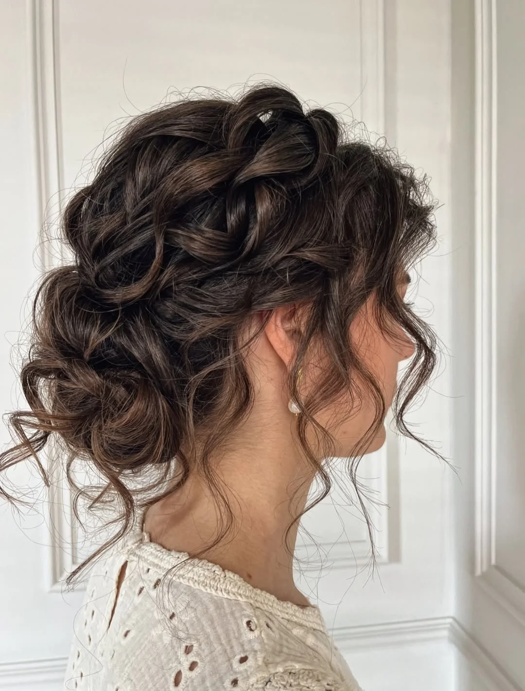messy summer bun hairstyles 2026 Romantic Curly Bun With Soft Volume