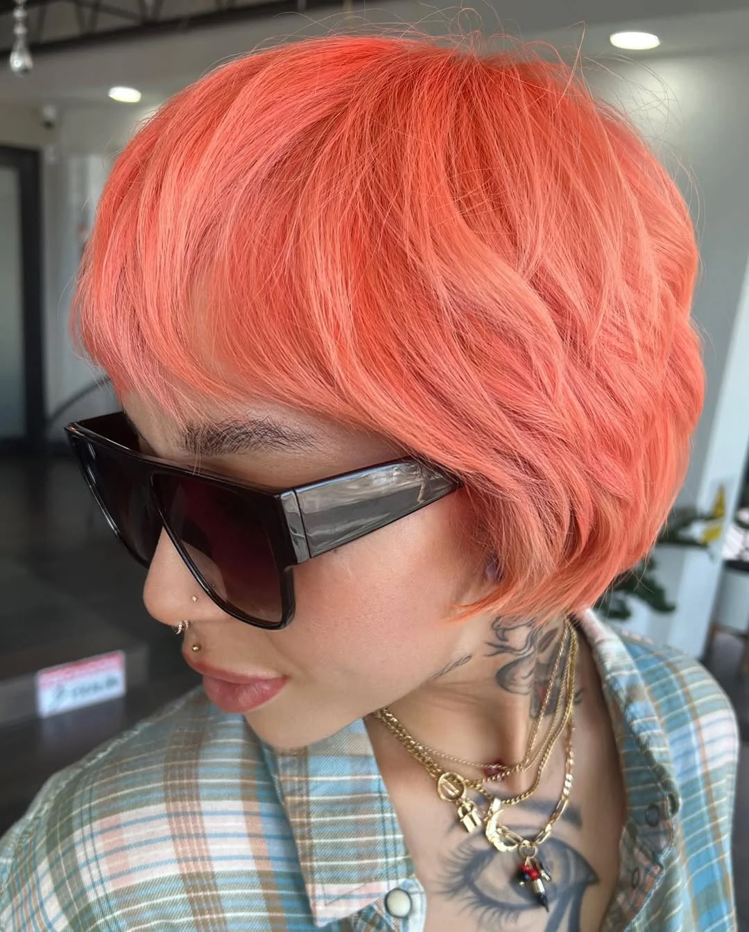 modern summer haircuts for women over 30 2026 Glossy coral crop with a fearless summer edge