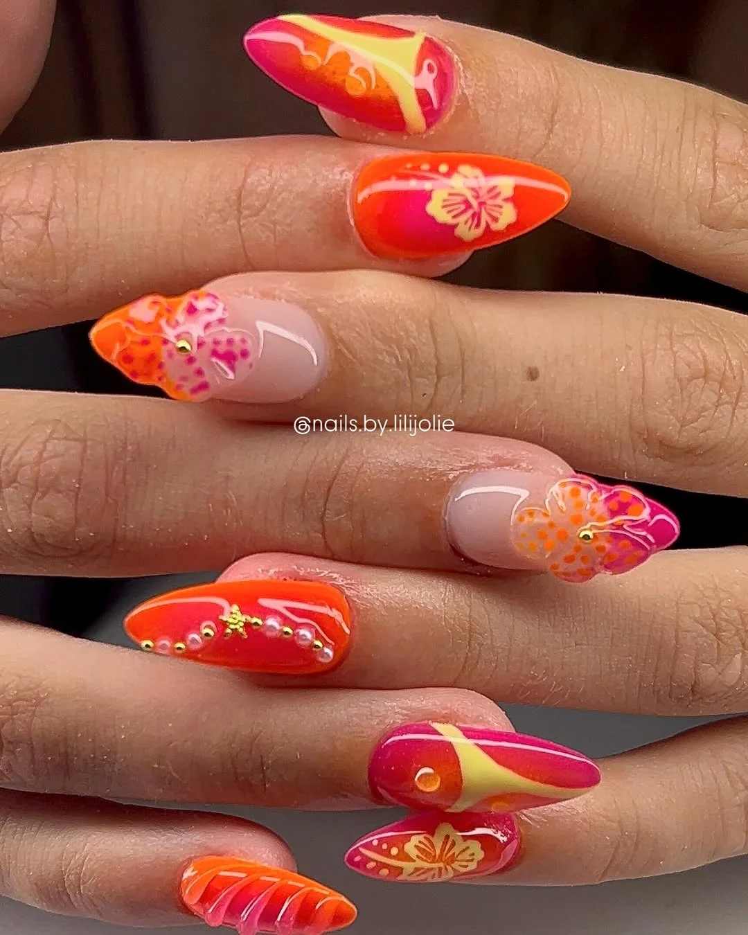 neon summer nails 2026 Orange And Pink Floral Neon Almond Nails