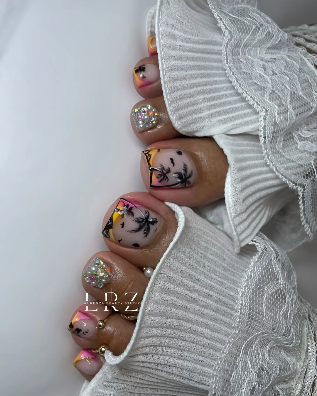 pedicure ideas summer trends 2026 Tropical Sunset Toenails With Rhinestone Details