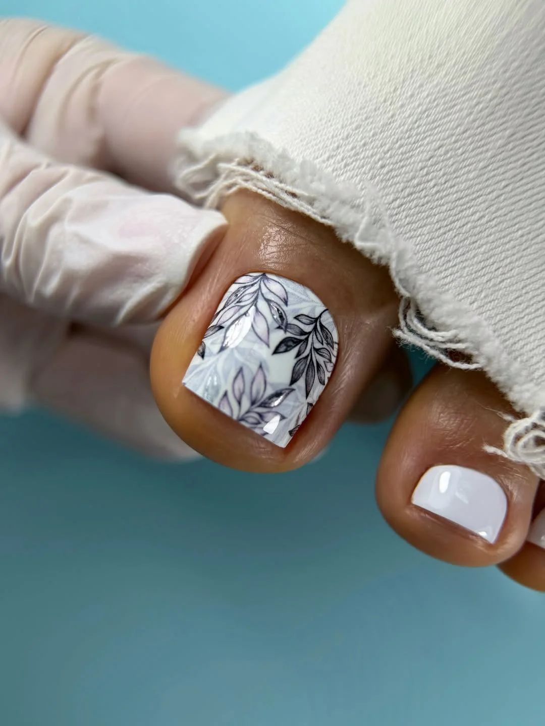 pedicure ideas summer trends 2026 Soft White Botanical Pedicure With Elegant Details