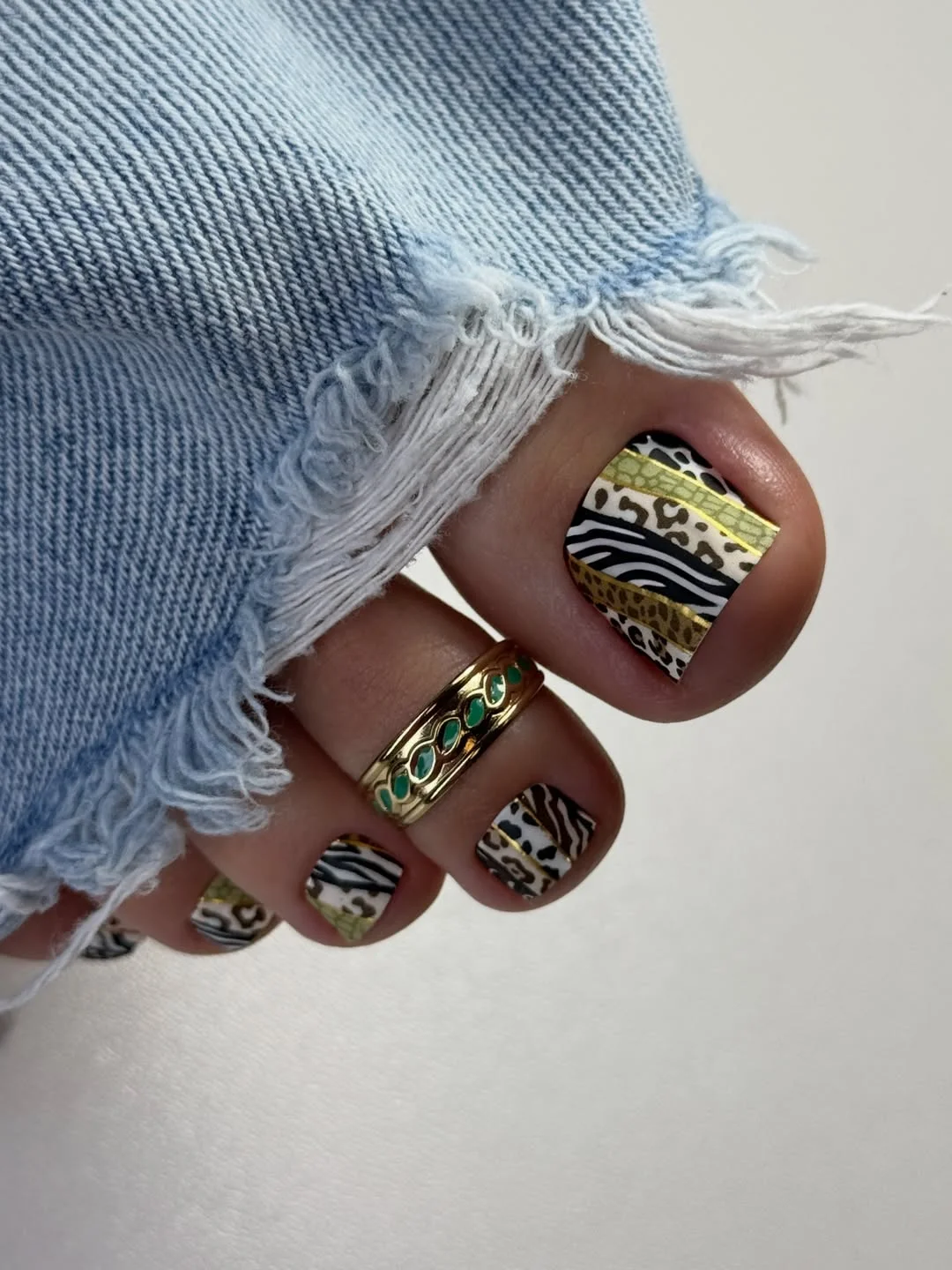 pedicure ideas summer trends 2026 Mixed Animal Print Pedicure With Gold Details