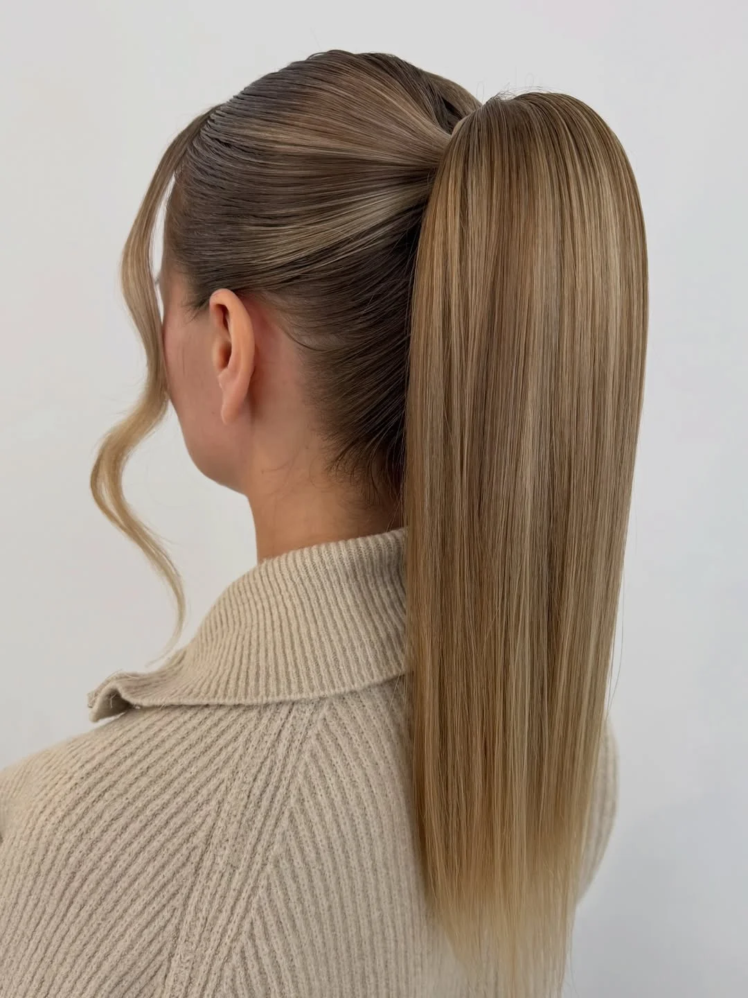 sleek summer ponytail hairstyle 2026 Sleek ponytail with soft swoop detail