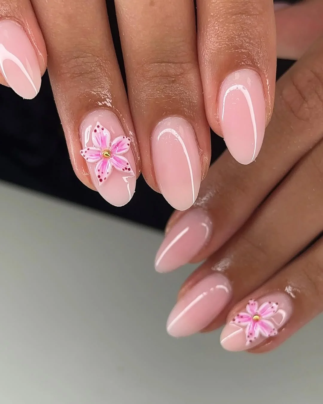 summer acrylic nails 2026 Simple Pink Almond Nails With Floral Accent